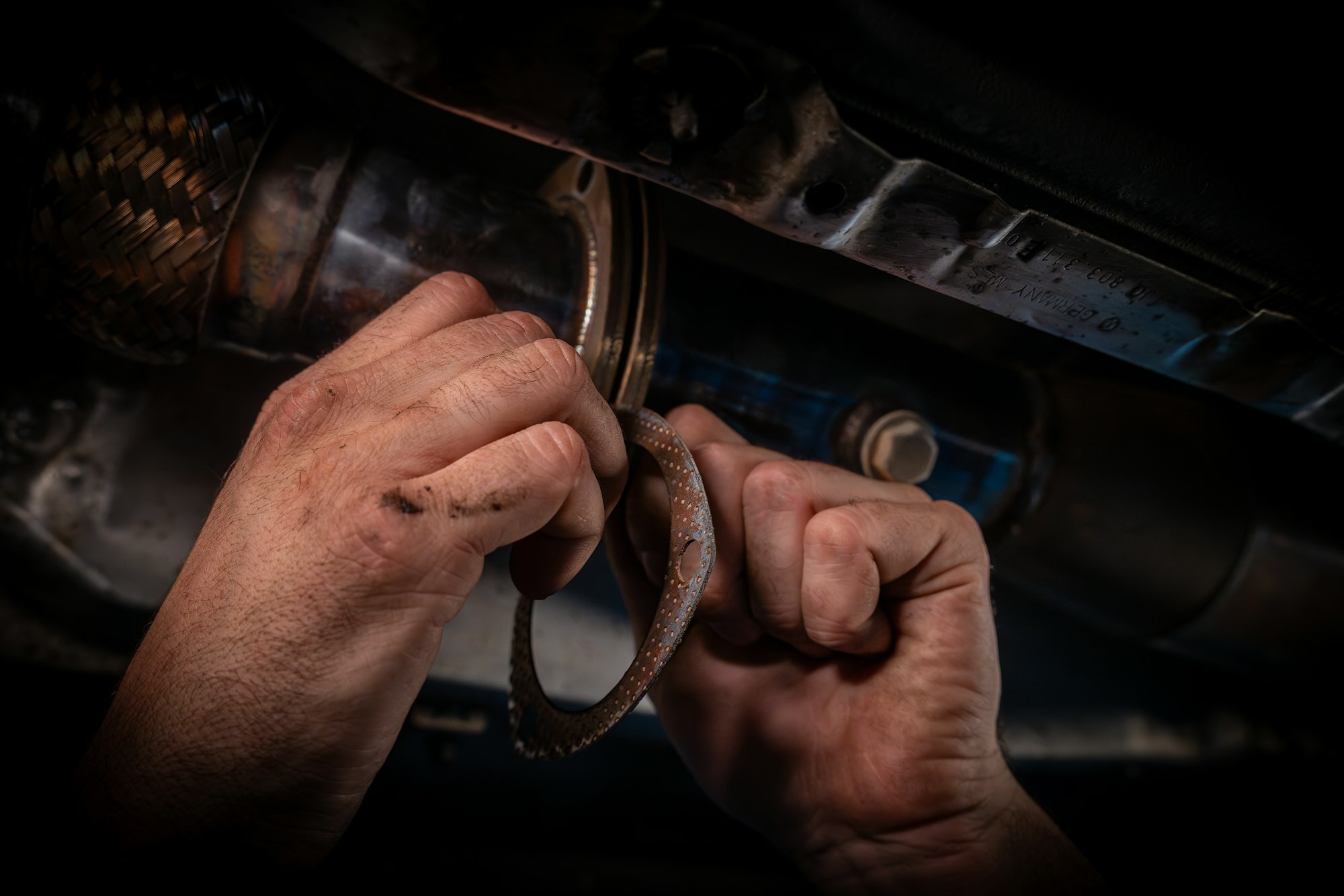 Underneath the car, fitting an exhaust gasket